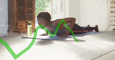 Woman exercising with green graph overlay in bright living room