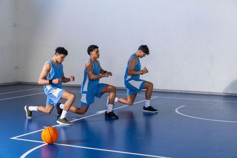 Athletes lunging during basketball training session