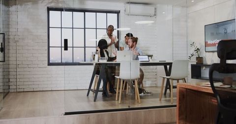Diverse Business Team in Glass Wall Meeting Room