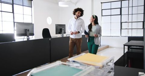 Colleagues Walking Conversation in Modern Office