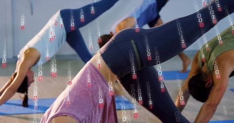Woman Practicing Three-Legged Downward Dog in Group Yoga Class with Digital Binary Overlay