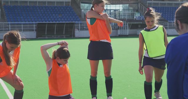 Female Field Hockey Players Preparing for Practice on Turf Field - Download Free Stock Images Pikwizard.com