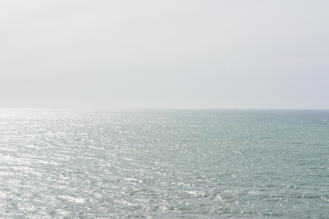 This image captures a calm ocean horizon under a cloudy sky, evoking feelings of tranquility and peace. Ideal for use in travel and tourism promotions, meditation and relaxation content, and nature-related materials. Suitable for backgrounds, screensavers, and environmental campaigns.