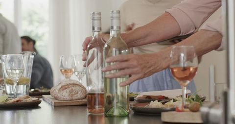 Elegant wedding reception with guests enjoying wine and appetizers