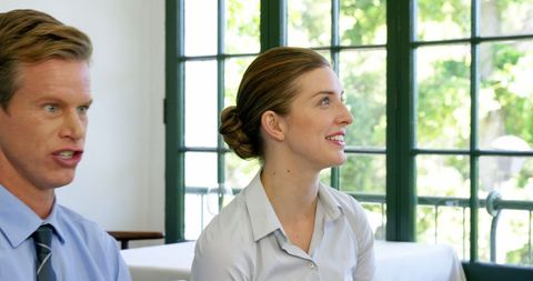 Smiling Business Professionals Engaged in Discussion After Office Hours