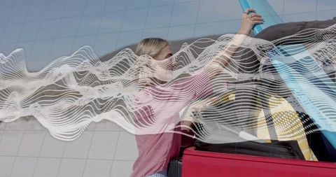 Woman Loading Surfboard into Car for Adventure Day Trip