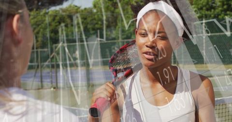Tennis Players Engaged in Conversation on Outdoor Court