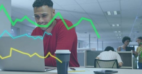 Young Professional Analyzing Laptop with Data Charts Overlay in Modern Open Office