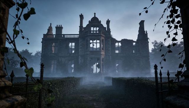 Fog-enshrouded dilapidated manor standing at end of hedged walkway with wrought-iron gate