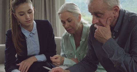 Senior Man and Family Reviewing Documents at Home