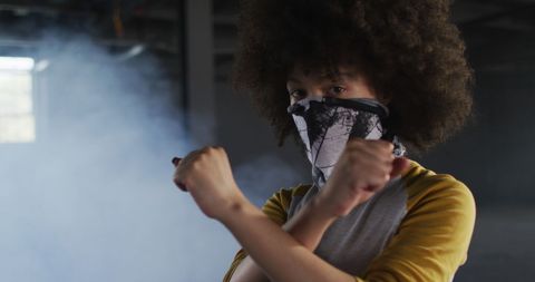Woman with face mask gesturing stop in urban environment