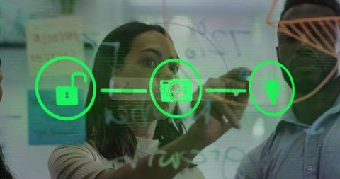 Innovative Businesswoman Sketching on Glass Board During Team Brainstorming Session