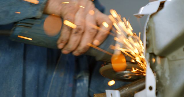 Metalworker Grinding Metal with Angle Grinder and Producing Sparks - Download Free Stock Images Pikwizard.com