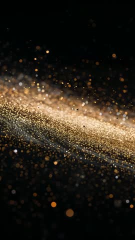 Vertical gold ribbon drifting across black with shimmering bokeh and glowing sparkle stream