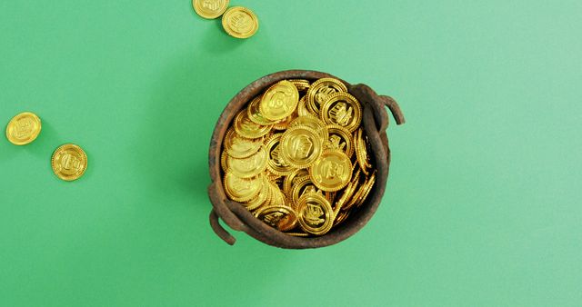 A round pot filled with shiny gold coins on green background representing wealth and good luck. Perfect for St. Patrick's Day celebrations or themes of prosperity, fortune, and treasure. Ideal for themed decorations, marketing materials, and promotions tied to holiday festivities.