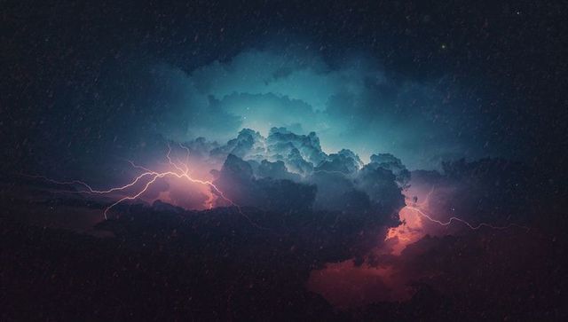 Glowing cumulonimbus cloud and lightning illuminating stormy sky