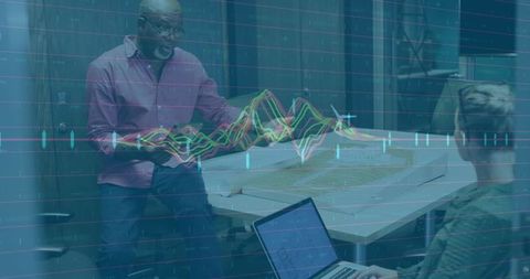 Senior professional presenting architectural model with data overlay in office meeting
