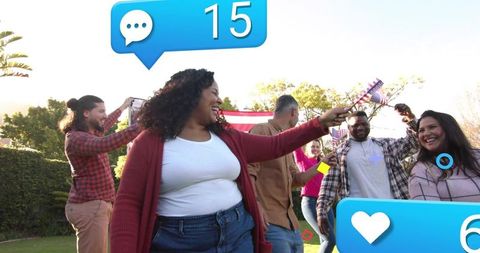 Friends celebrating with American flags in backyard, joyful patriotic summer party