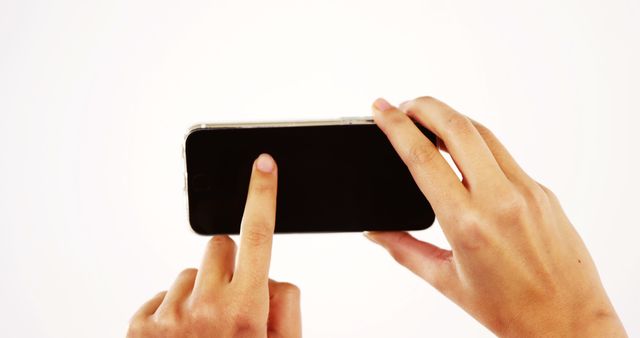 Close-Up Hands Holding Smartphone Horizontally on White Background - Download Free Stock Images Pikwizard.com