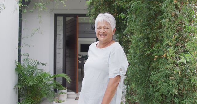 Smiling Mature Woman Standing in Lush Green Garden - Download Free Stock Images Pikwizard.com