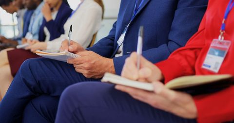 Diverse Business Team Taking Notes at Seminar
