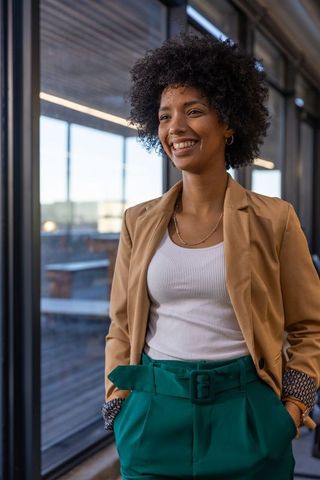 Confident Professional Woman Posing in Modern Urban Workspace
