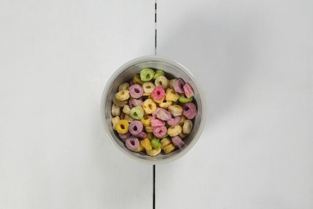 Froot loops in bowl on white background