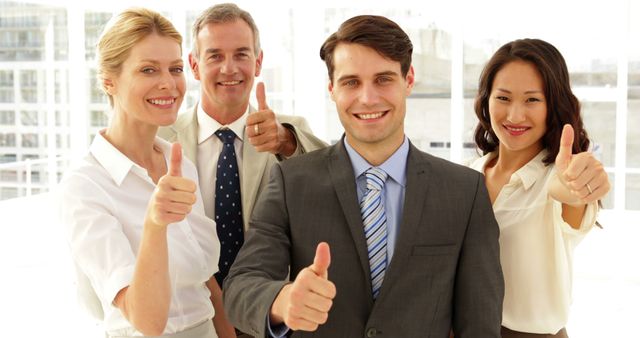 Business team giving thumbs up to the office - Download Free Stock Photos Pikwizard.com