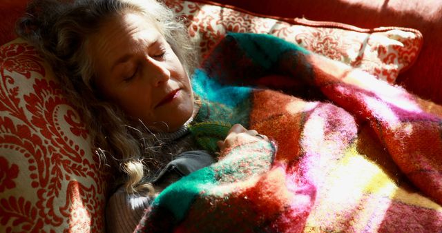 Sleeping woman enjoying cozy nap covered with colorful blanket on couch - Download Free Stock Images Pikwizard.com