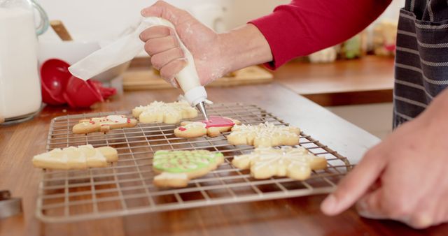 Decorating Cookies on Cooling Rack with Icing in Kitchen - Download Free Stock Images Pikwizard.com