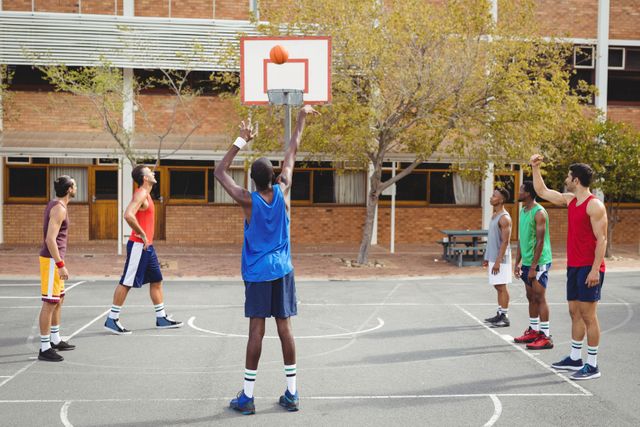 Basketball player taking a penalty shot in basketball court outdoors