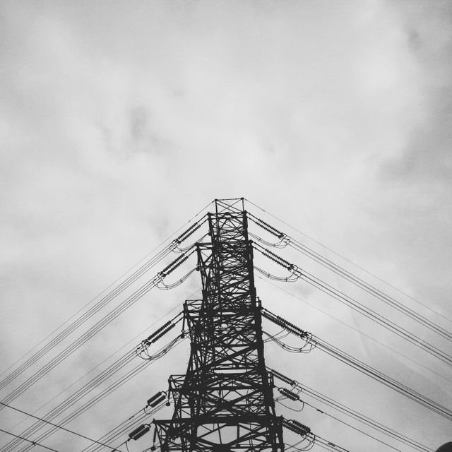 Black and White View of Electrical Tower against Cloudy Sky - Download Free Stock Photos Pikwizard.com