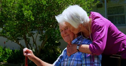 Caucasian Senior Couple Embracing in Lush Garden