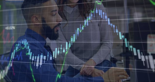 Business professionals analyzing stock market data on computer screen in office composed with overlaid graph. Useful for articles and materials related to finance, stock trading, investment strategies, teamwork, data analytics, and workplace technology.