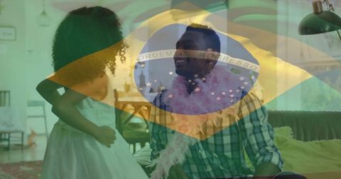 Father and daughter play dress-up with brazilian flag atmosphere