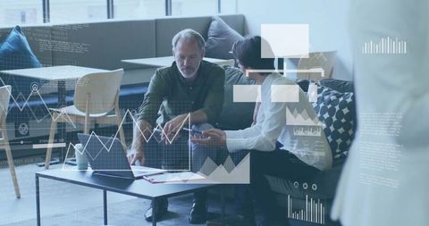 Two businessmen analyzing data in modern office lounge