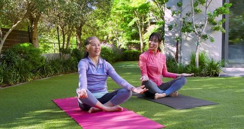 Mother and Daughter Enjoying Outdoor Yoga on Artificial Turf