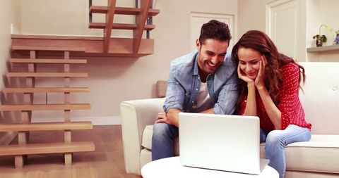 Happy Couple Smiling at Laptop Screen in Cozy Living Room - Download Free Stock Images Pikwizard.com