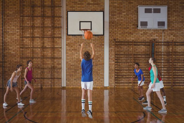Teenagers Playing Basketball in School Gymnasium - Download Free Stock Photos Pikwizard.com