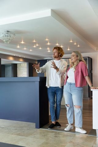 Couple Touring Contemporary Kitchen with Modern Elegance