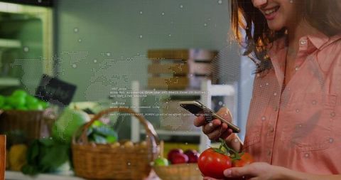 Woman Scanning Tomatoes with Smartphone at Local Market