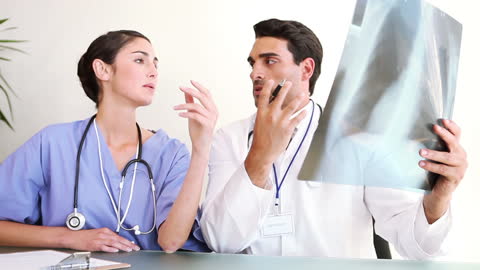 Two Doctors Analyzing X-ray in Office Setting