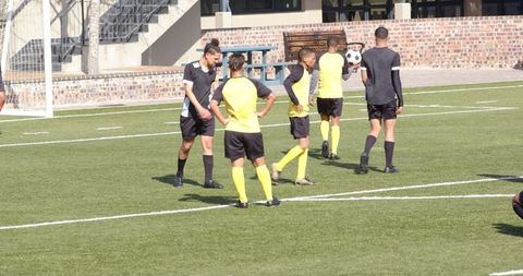 Soccer Players Preparing Game Strategy on Field