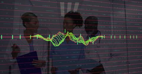 Medical professionals analyzing patient data on vital signs monitor