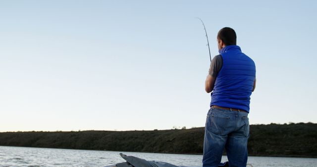 Man Fishing on Calm Lake at Sunset - Download Free Stock Images Pikwizard.com
