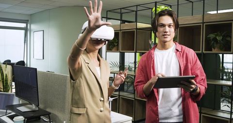 Colleagues Experiencing Virtual Reality in Modern Office Space