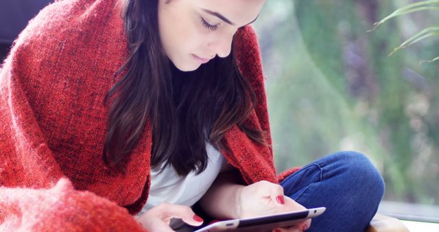 Young Woman Reading E-Book Under Cozy Red Blanket - Download Free Stock Images Pikwizard.com