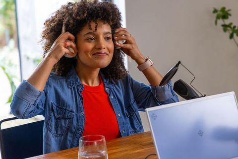 African american woman wearing headphones for podcasting and remote content creation