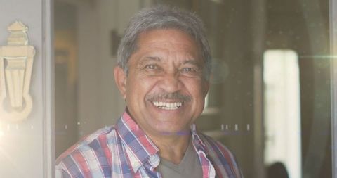 Senior man smiling in warm light for retirement concepts