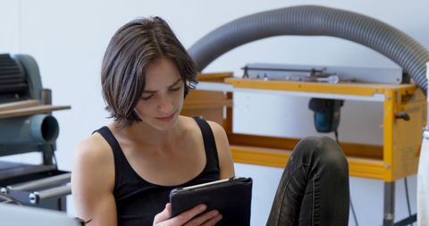 Young Woman Using Tablet in School Workshop